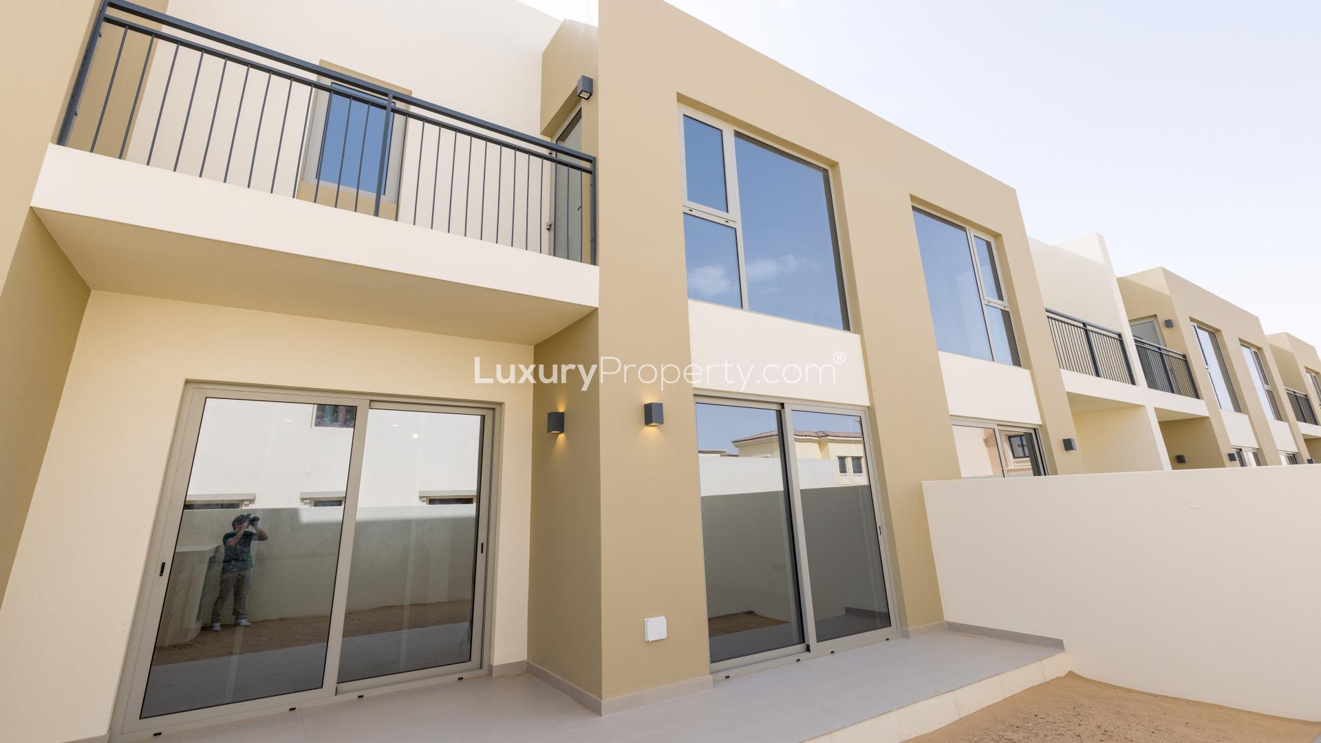 "Spacious living area with large windows in Camelia townhouse, Arabian Ranches 2, for rent.",Modern 3-bedroom townhouse exterior in Camelia, Arabian Ranches 2, single row for rent
