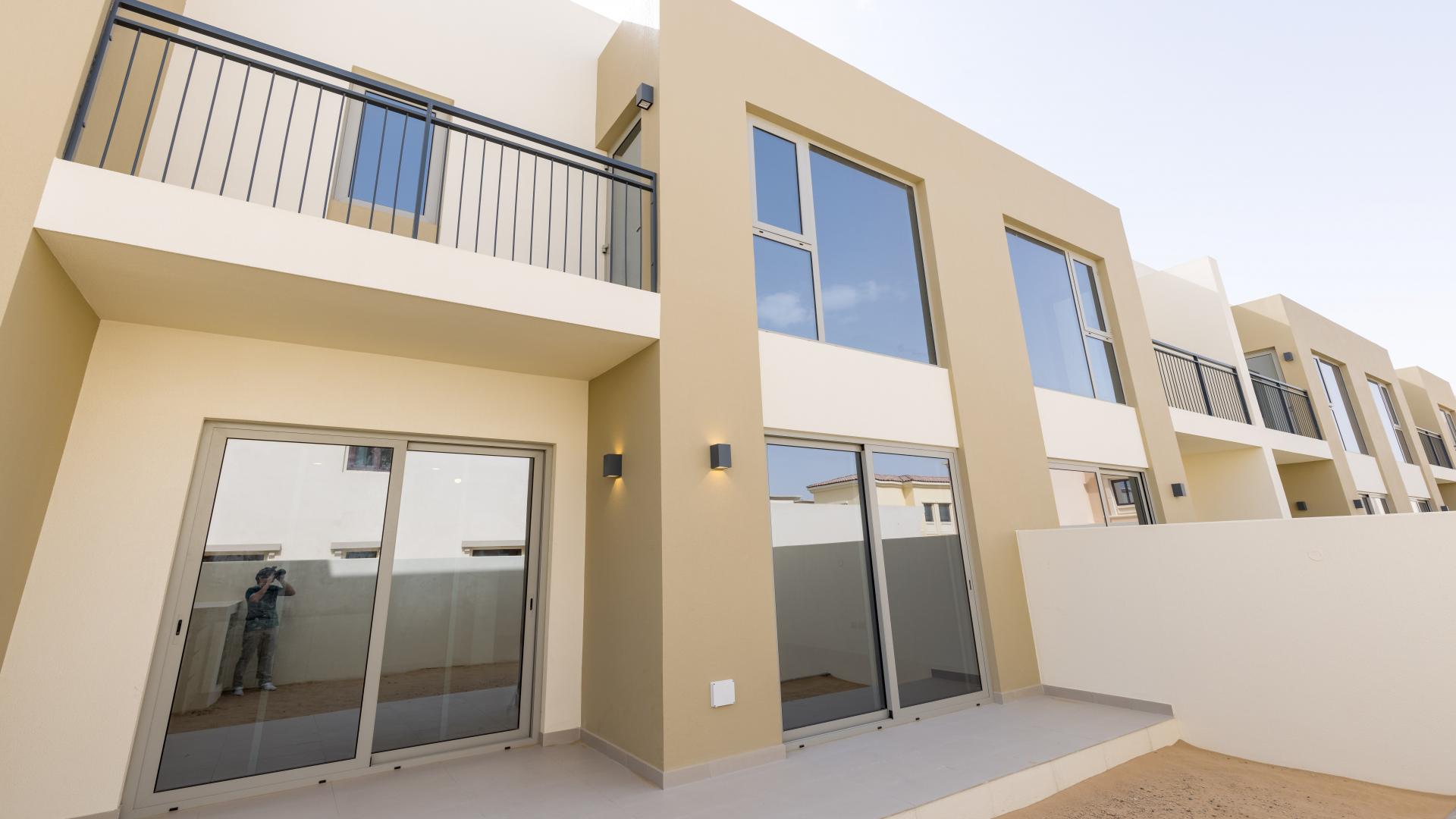 "Spacious living area with large windows in Camelia townhouse, Arabian Ranches 2, for rent.",Modern 3-bedroom townhouse exterior in Camelia, Arabian Ranches 2, single row for rent