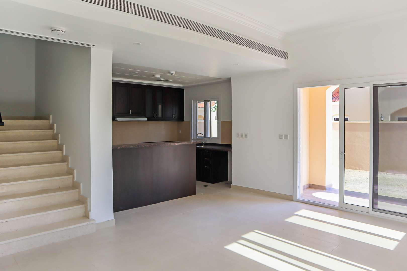 Modern kitchen and staircase in 3-bedroom villa, Casa Viva, Serena, Dubailand townhouse for rent