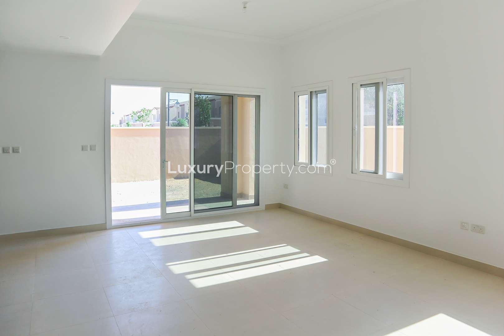 Bright 3-bedroom townhouse exterior in Casa Viva, Serena, Dubailand, with driveway and garden