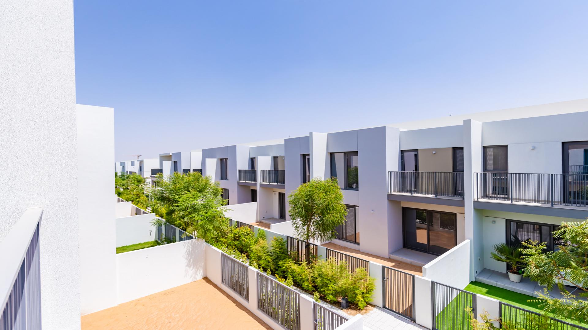 Modern living room with large windows in Tilal Al Ghaf townhouse, Dubai