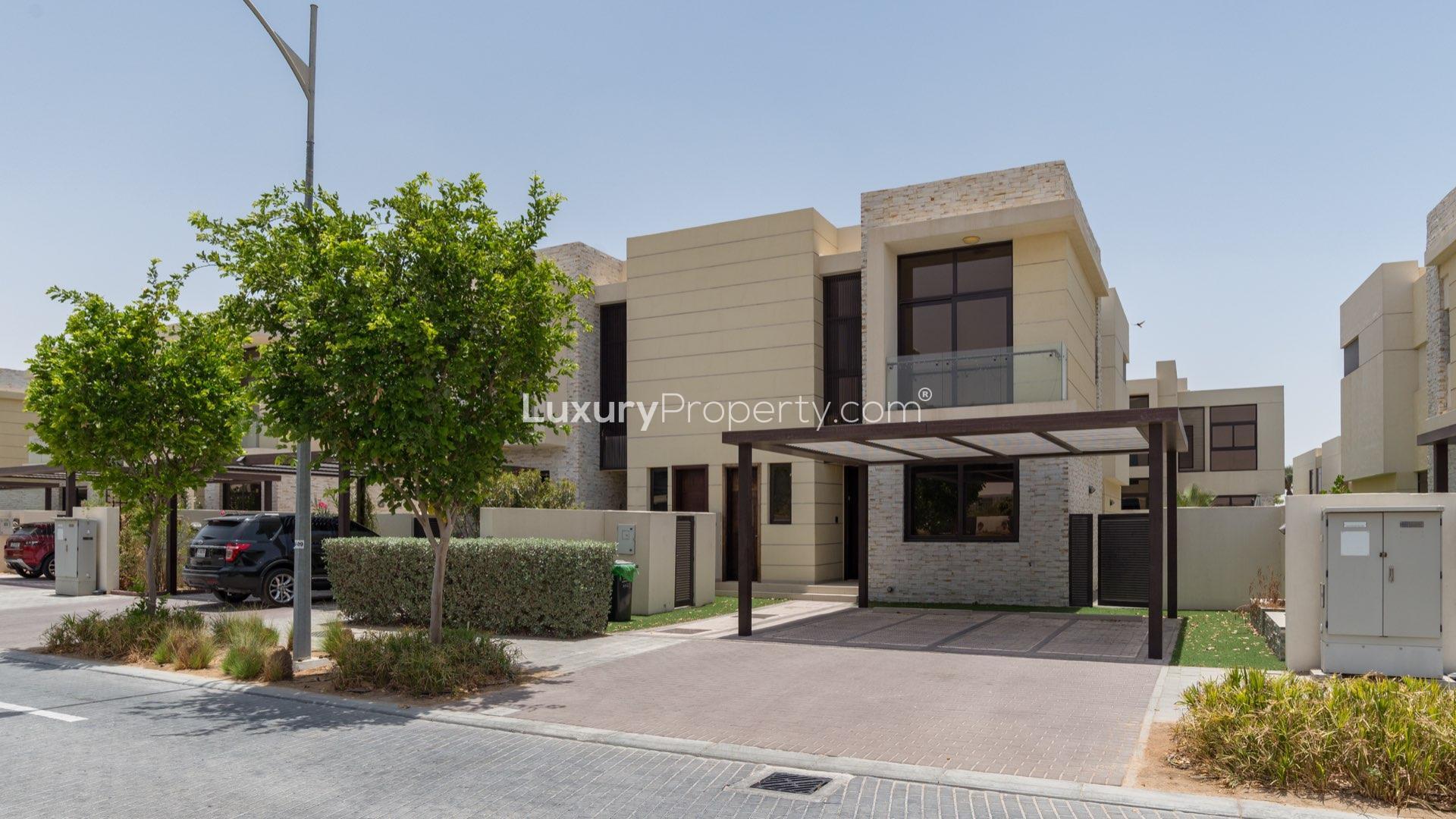 Modern THL-type townhouse exterior with pergola in Flora, Damac Hills, available for rent