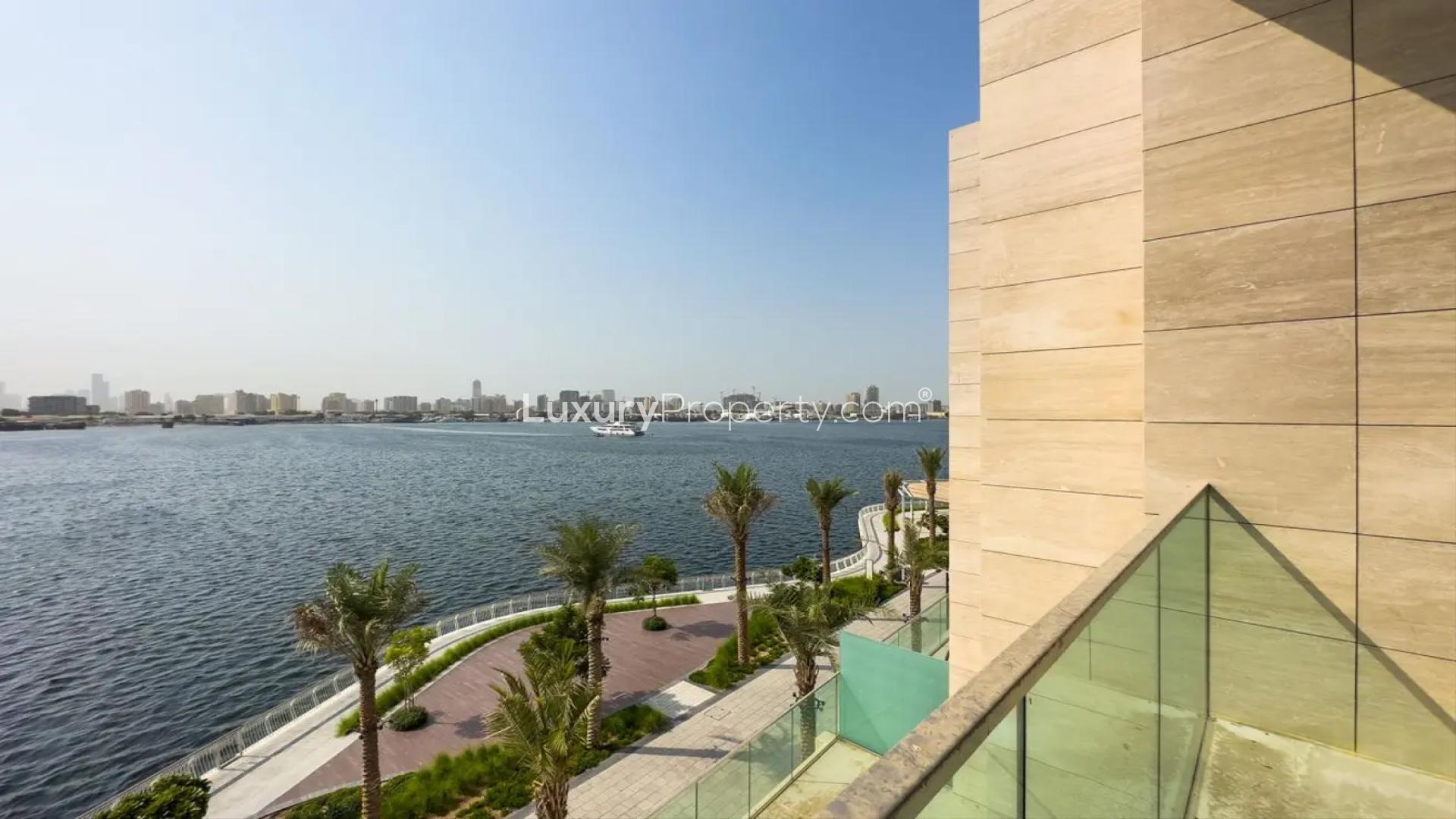 "Bright room with large windows and waterfront view in Dubai Creek Harbour townhouse.",Scenic waterfront view from townhouse in The Grand, Dubai Creek Harbour