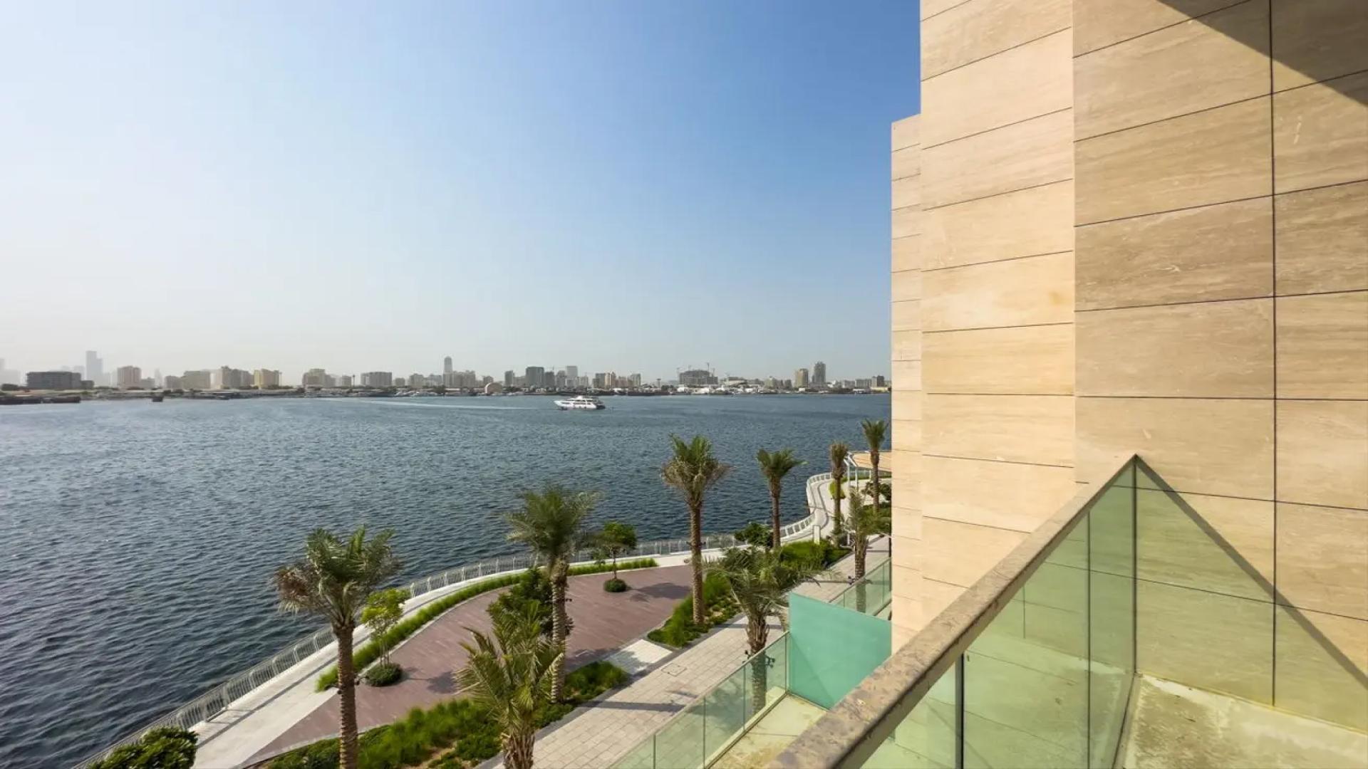 "Bright room with large windows and waterfront view in Dubai Creek Harbour townhouse.",Scenic waterfront view from townhouse in The Grand, Dubai Creek Harbour
