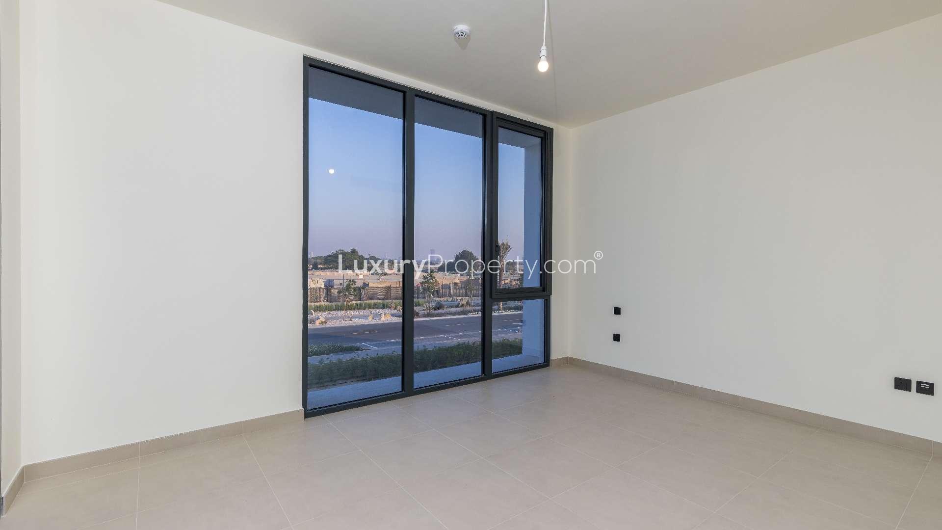 Empty room with large windows in Dubai Hills Estate villa, Golf Grove community