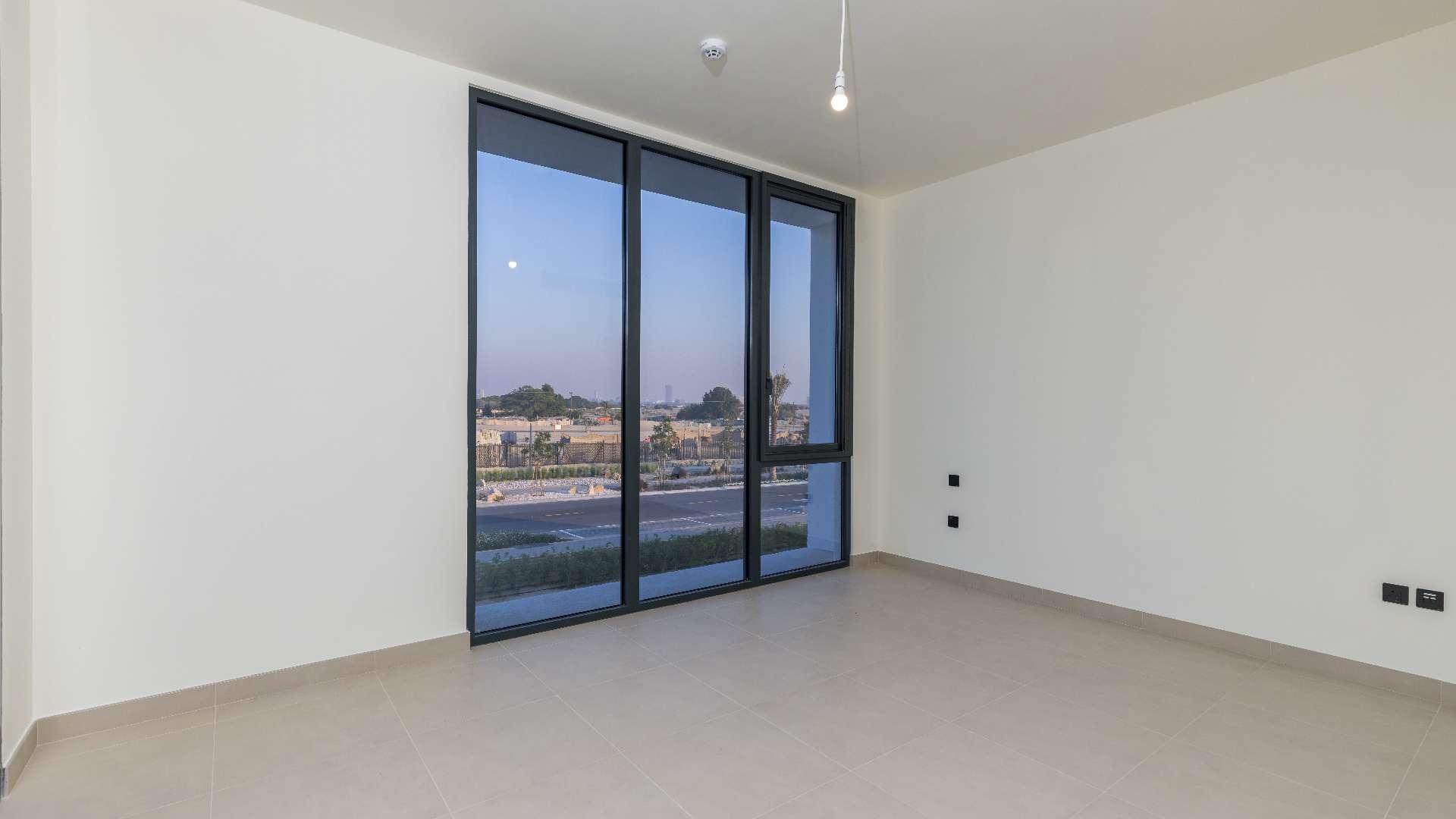 Empty room with large windows in Dubai Hills Estate villa, Golf Grove community