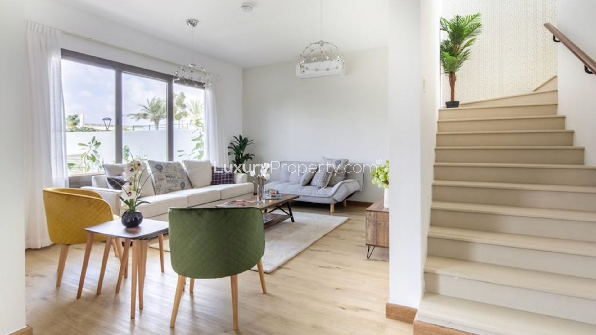 View of Hayat Town Square townhouse community with tennis courts and landscaped gardens