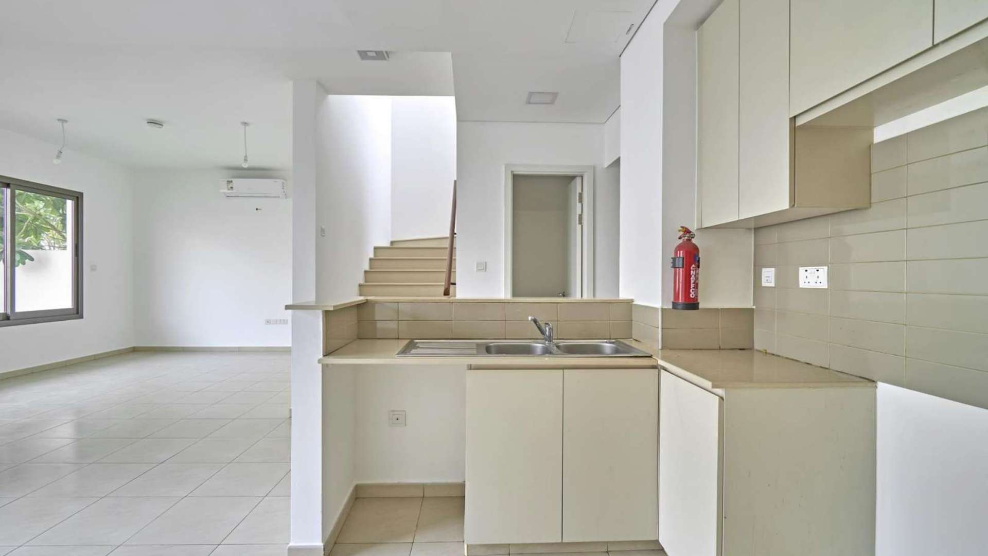 3-bedroom townhouse exterior in Hayat, Town Square, with parking and tree-lined street