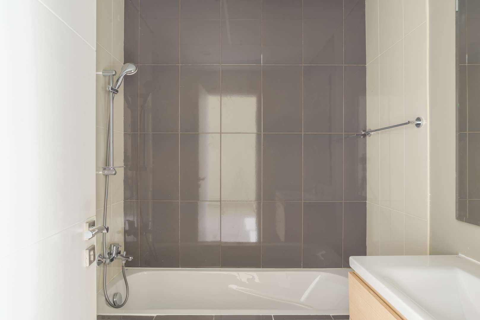 "Bright bedroom with built-in wardrobe and balcony in Damac Hills 2 townhouse for rent.",Modern bathroom in 3-bedroom townhouse, Janusia, Damac Hills 2, available for rent