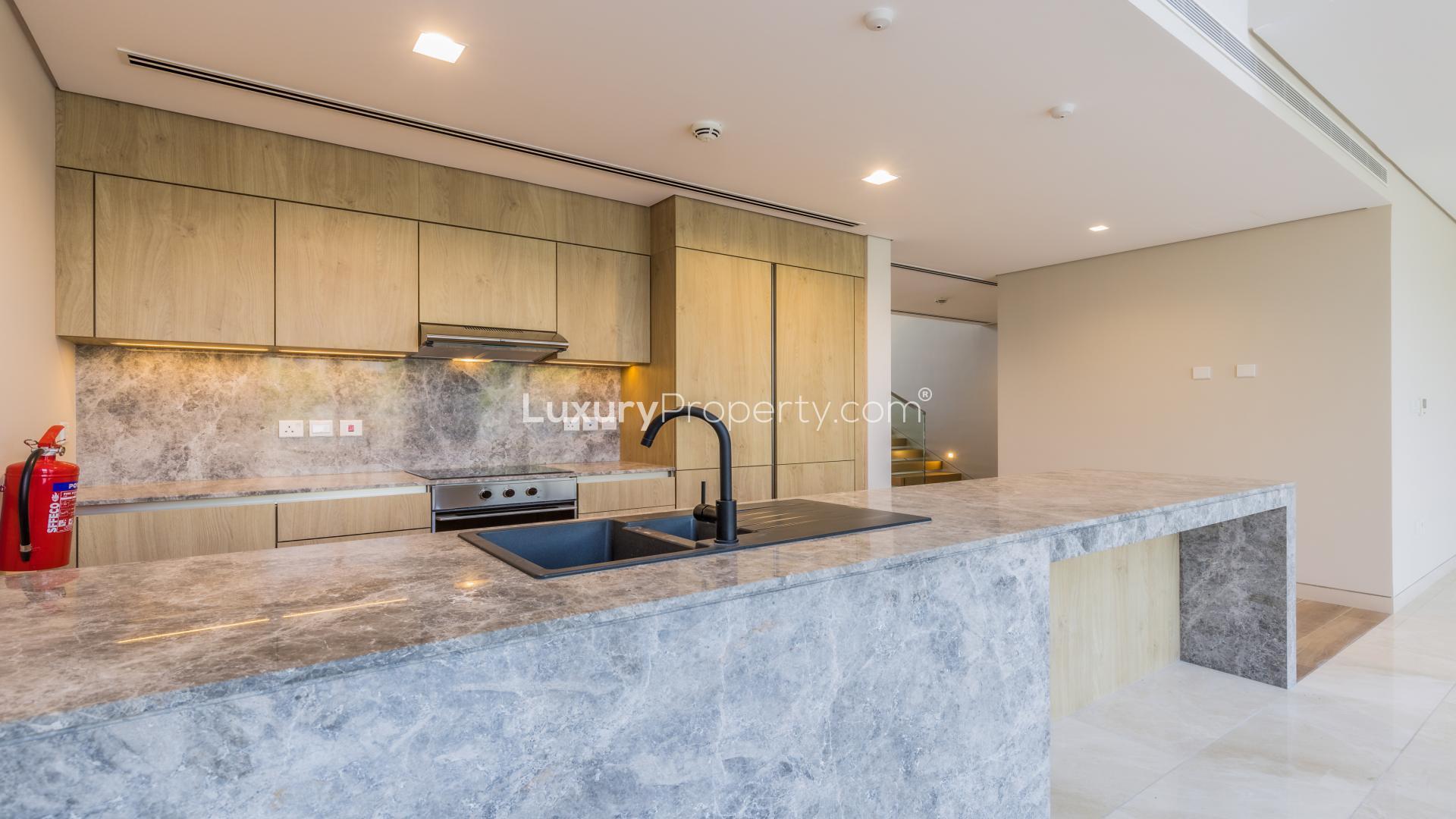 Spacious living area in Jumeirah Bay Island townhouse with large windows and tiled floors