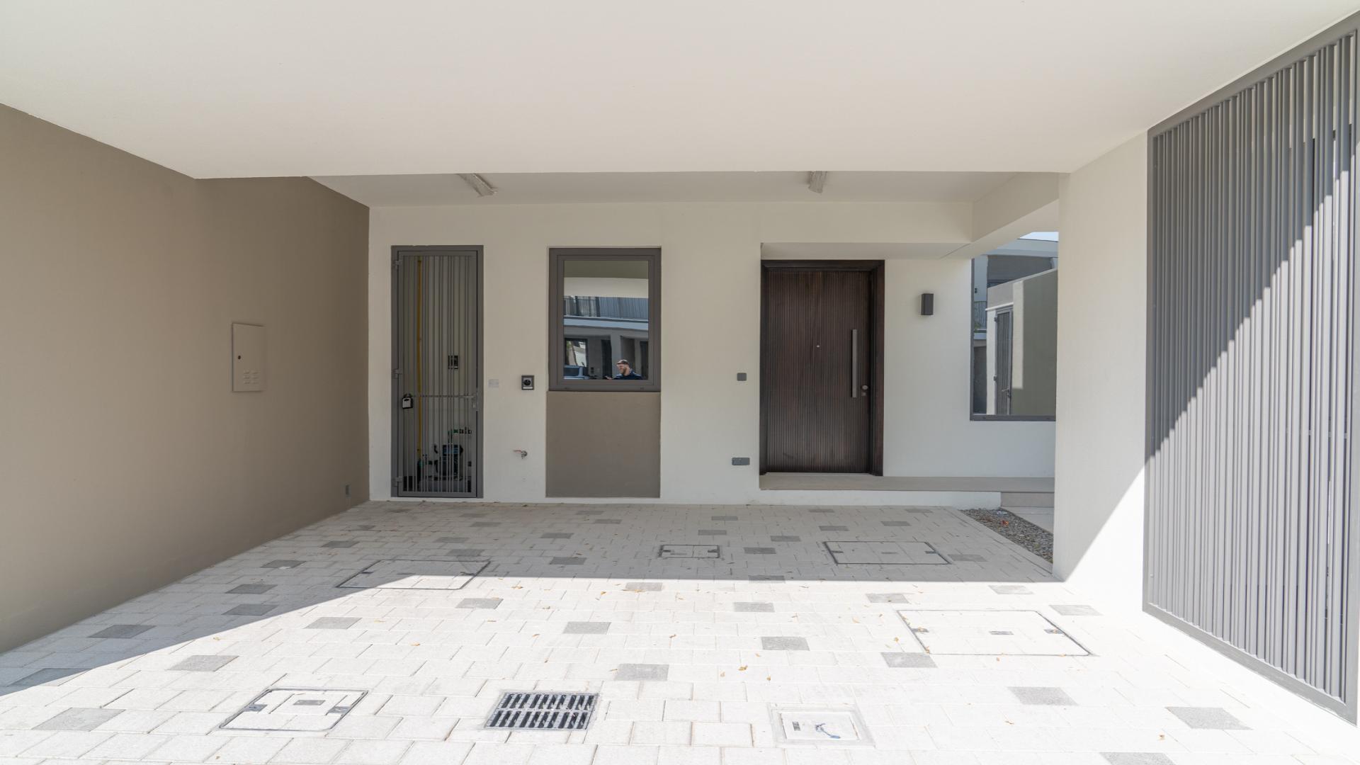 Bright living area with large windows in Aura Gardens townhouse, Tilal Al Ghaf