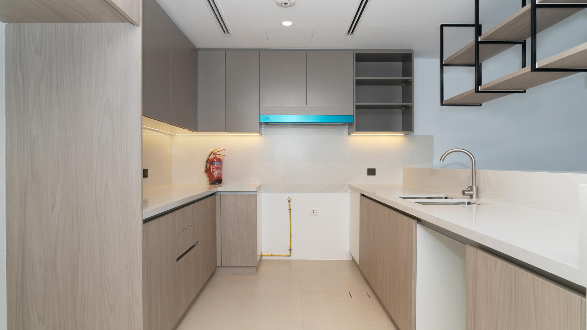 Townhouse balcony view in Aura Gardens, Tilal Al Ghaf community, sunny day scene