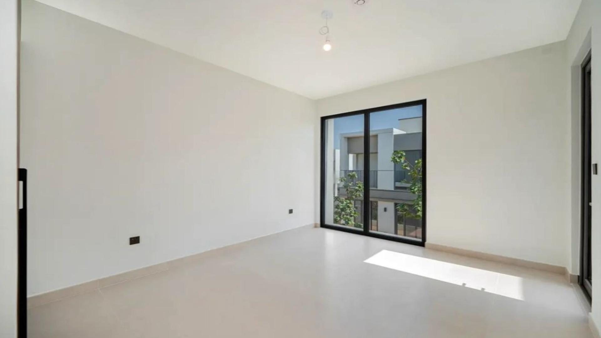 Modern open-plan kitchen and living area in Tilal Al Ghaf townhouse for rent, Aura Gardens