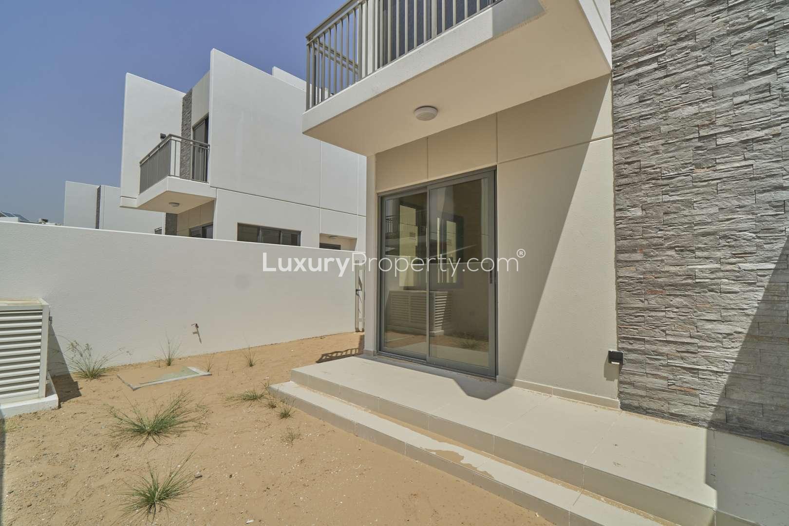 Bright empty room with window in Damac Hills 2 townhouse, available for rent