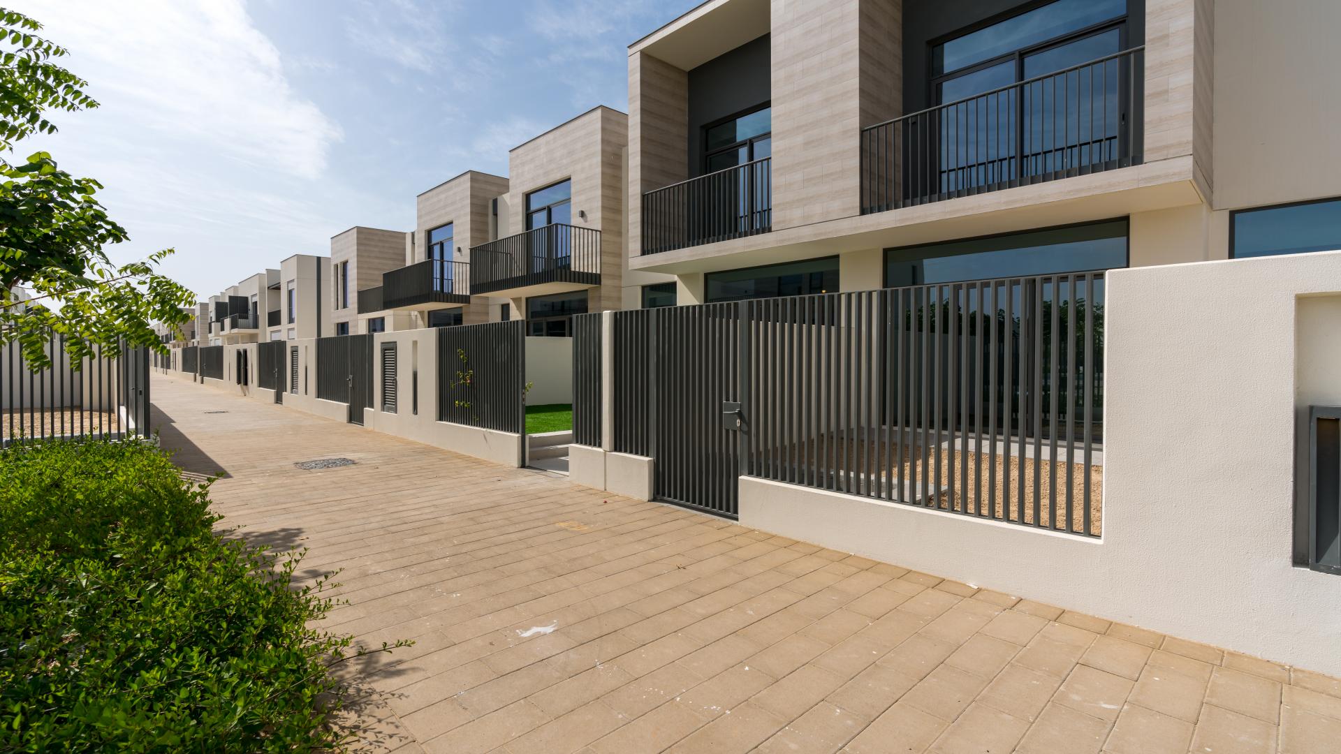 Luxurious townhouse exterior in Joy, Arabian Ranches III, featuring modern architecture and private entrance