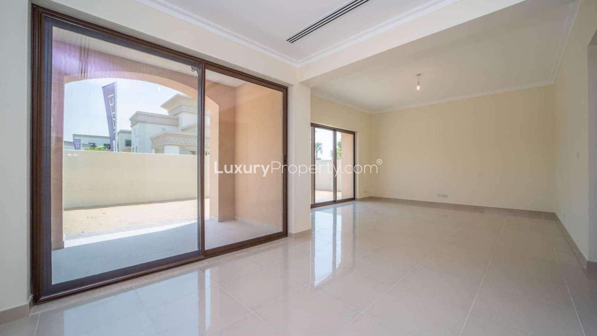 Modern kitchen in 3-bedroom villa, Arabian Ranches 2, featuring granite countertops and wood cabinetry