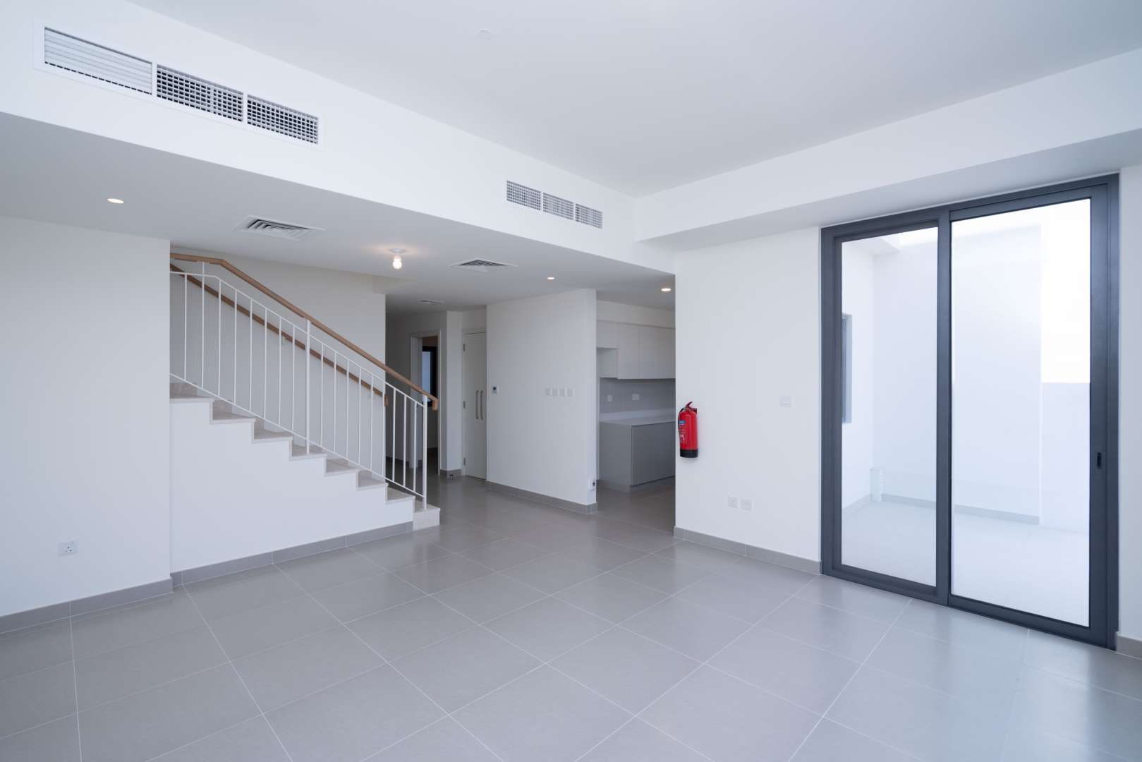 Interior view of a spacious townhouse in Maple, Dubai Hills Estate with modern staircase
