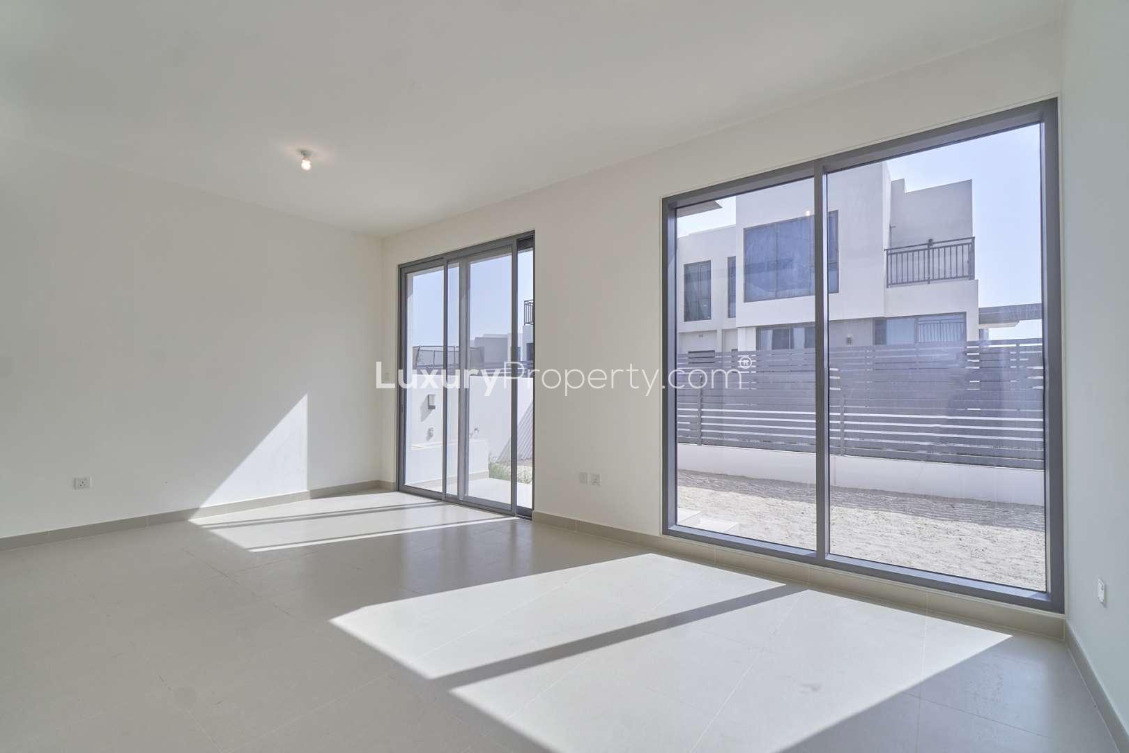 Exterior of three-bed villa in Maple, Dubai Hills Estate, with carport and driveway