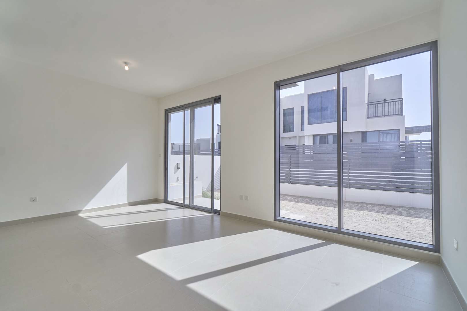 Exterior of three-bed villa in Maple, Dubai Hills Estate, with carport and driveway