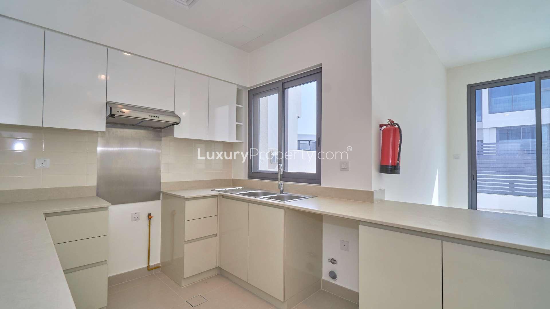 Modern townhouse exterior with driveway in Maple, Dubai Hills Estate, available for rent