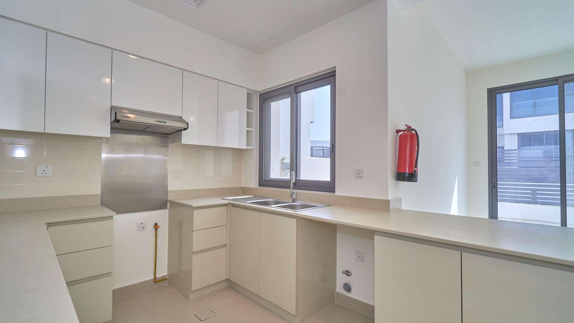 Modern townhouse exterior with driveway in Maple, Dubai Hills Estate, available for rent