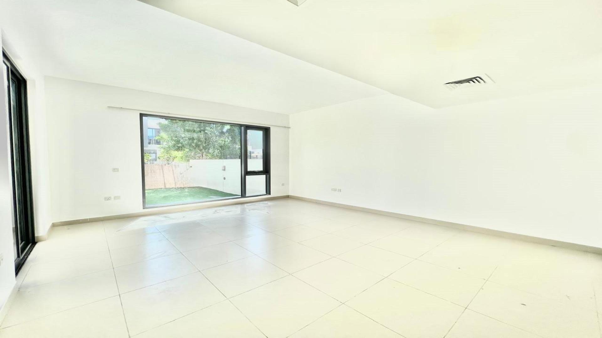 Bright living room in 3-bedroom villa, Maple 2, Dubai Hills Estate, with garden view