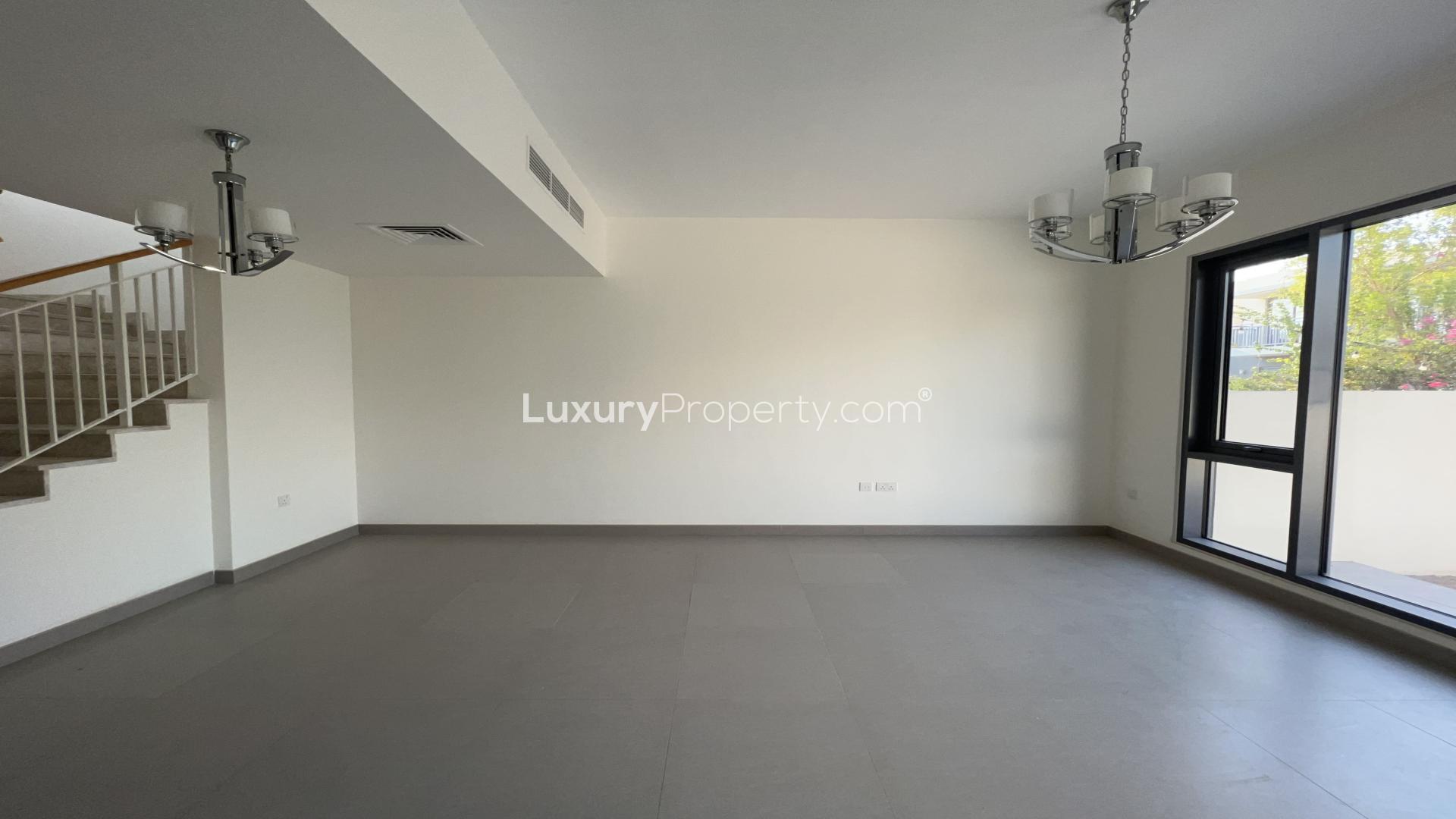 Spacious living area in Dubai Hills Estate villa with modern design and sliding doors