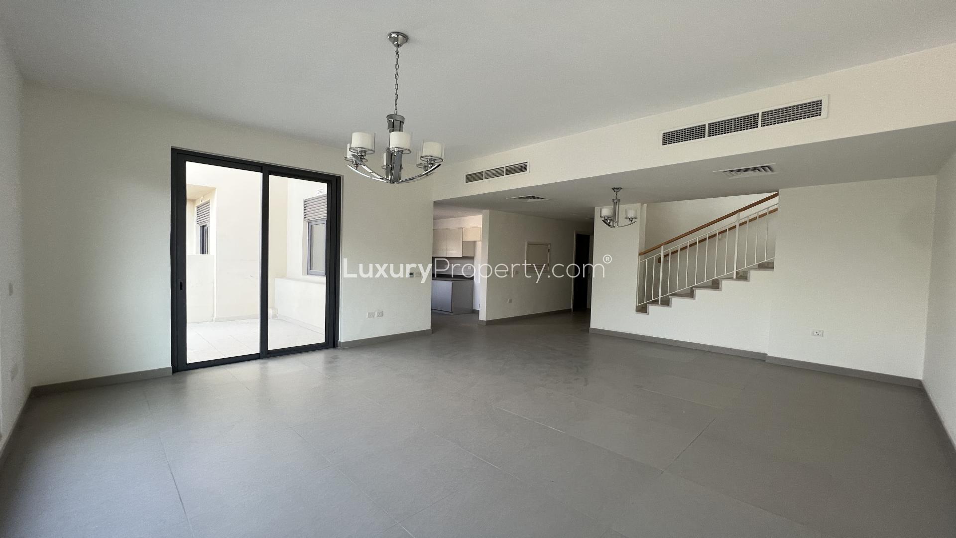 Modern Dubai Hills villa exterior with spacious lawn and balcony, Maple community