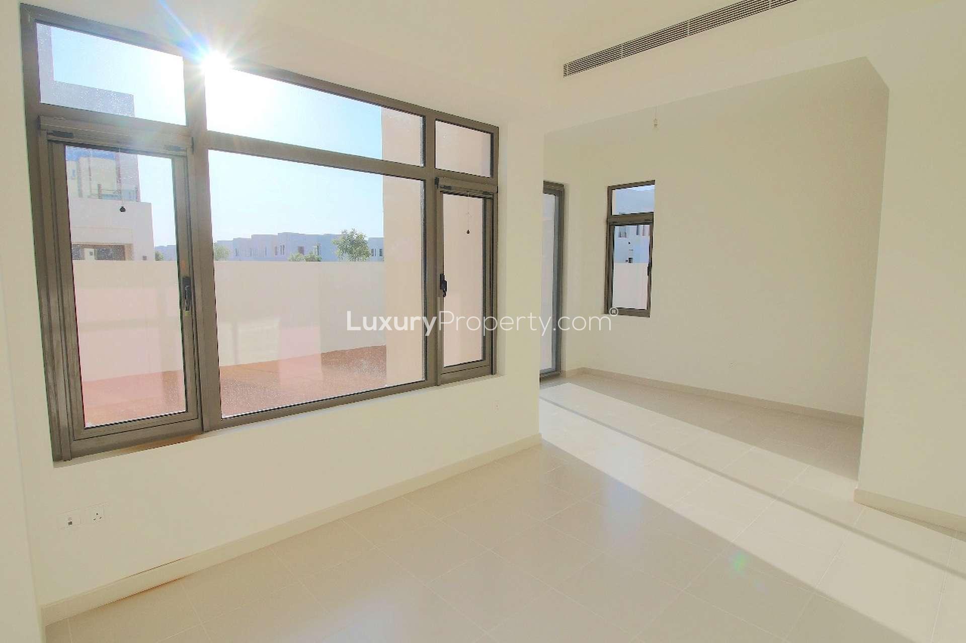 Empty room with large windows in Mira Oasis 1 townhouse for rent