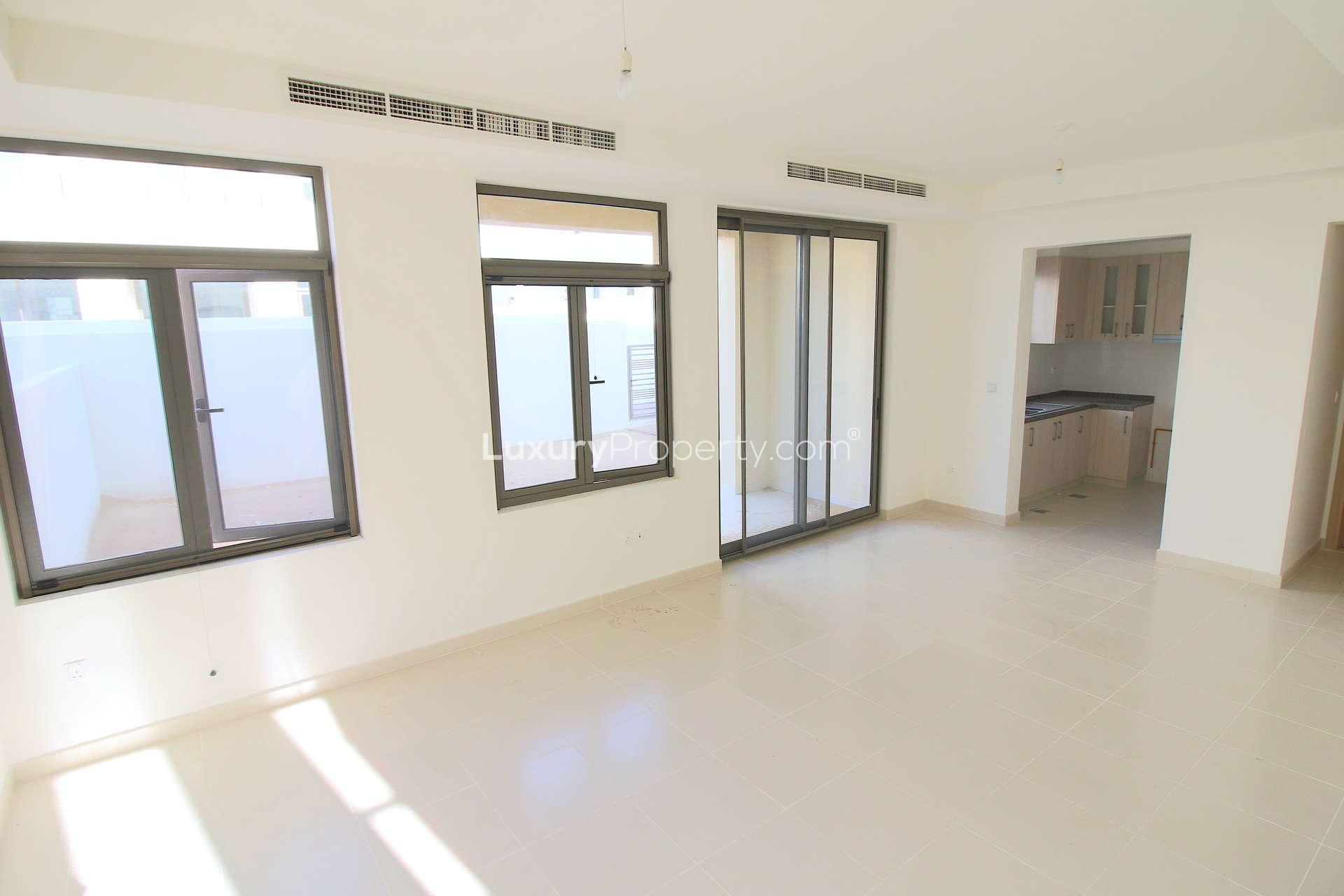 Bright living room with large windows in Mira Oasis 3 townhouse, Reem