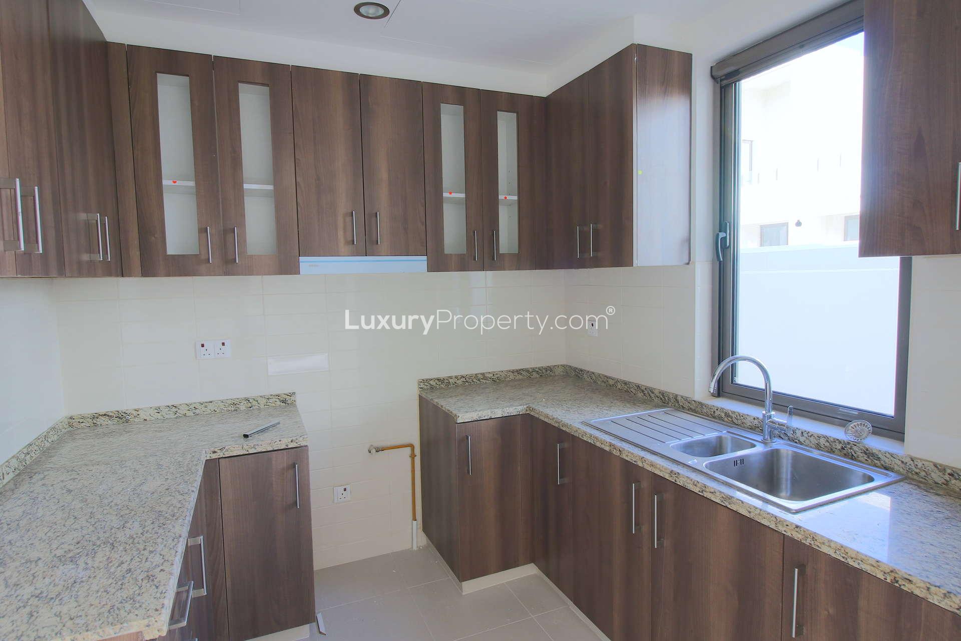 Bright living area in 3-bedroom townhouse, Mira Oasis, Dubai, with large windows and tiled floors