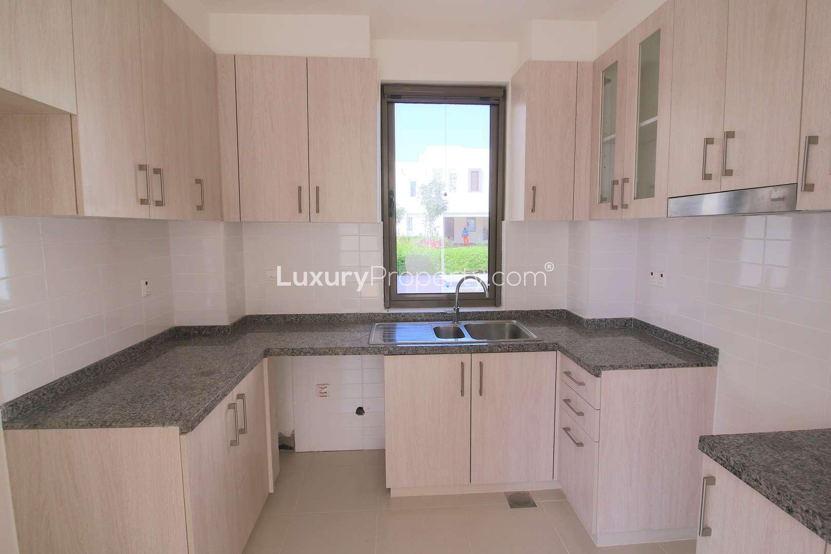 Bright living room with large windows in Mira Oasis townhouse for rent, Reem community