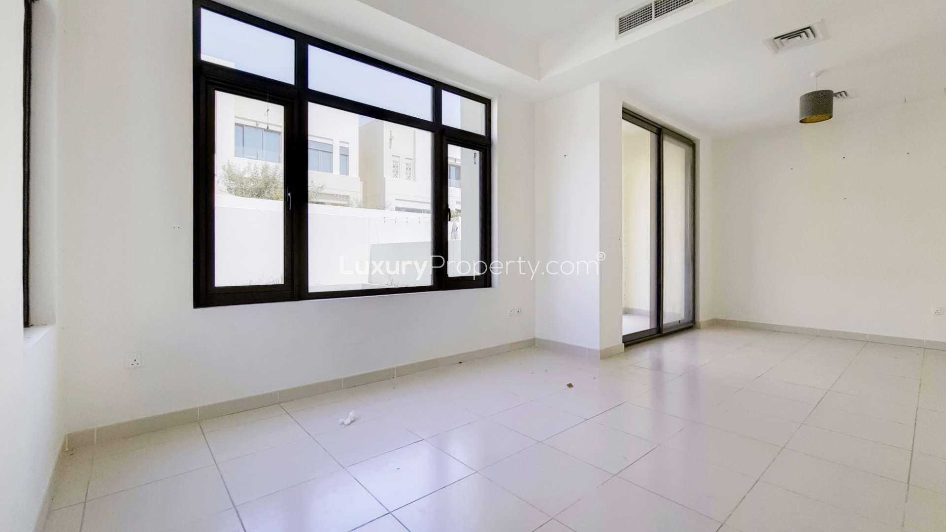 Modern townhouse exterior in Mira Oasis 3, Reem community, surrounded by greenery and roads