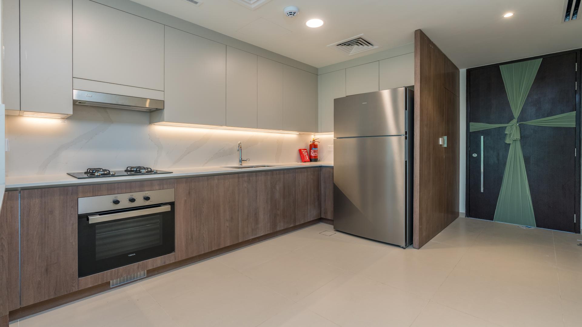 Modern kitchen and living area in Tilal Al Ghaf townhouse, Elan community