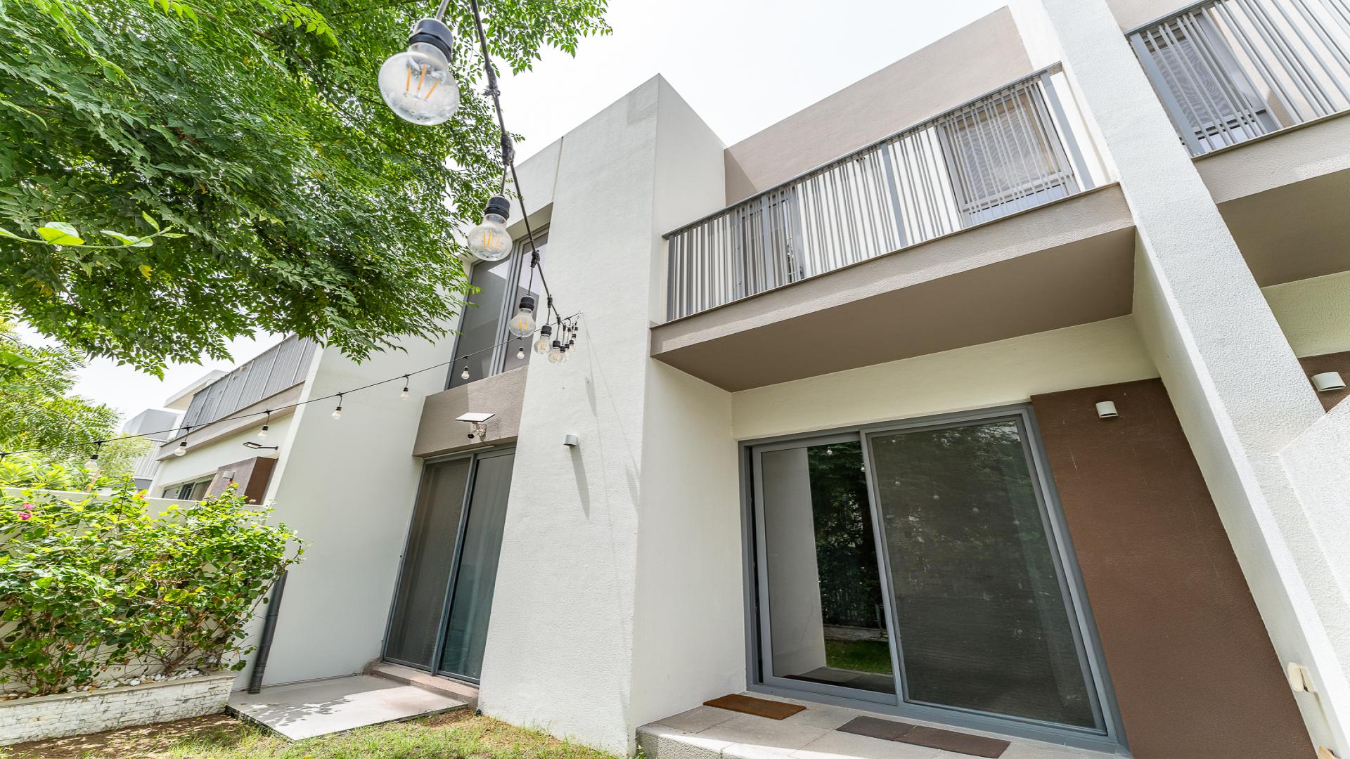 Modern kitchen in Elan townhouse, Tilal Al Ghaf, with garden view and sleek design