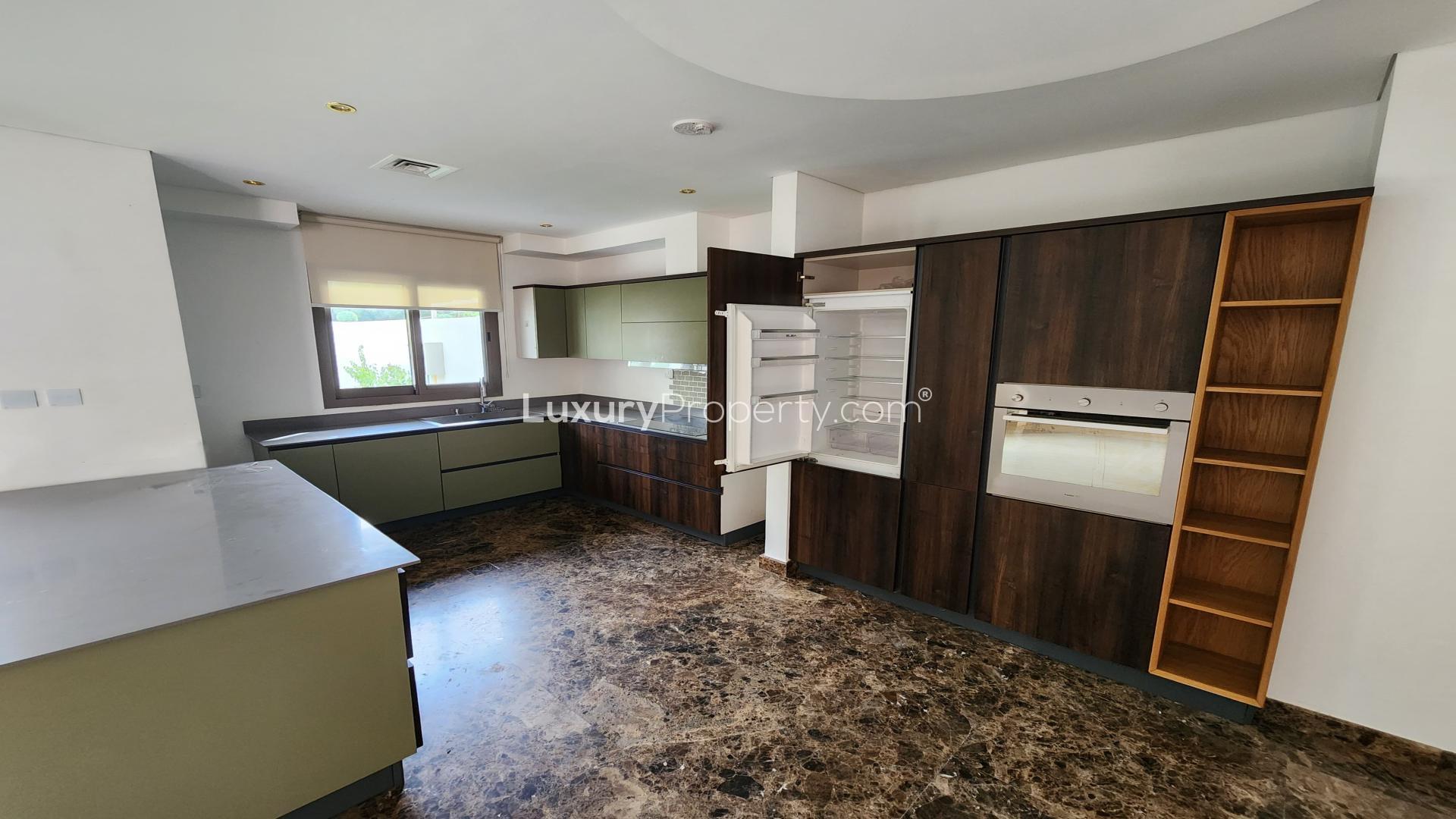 Modern kitchen in 3-bedroom townhouse, Zahra Town Square Dubai, with sleek cabinets and appliances