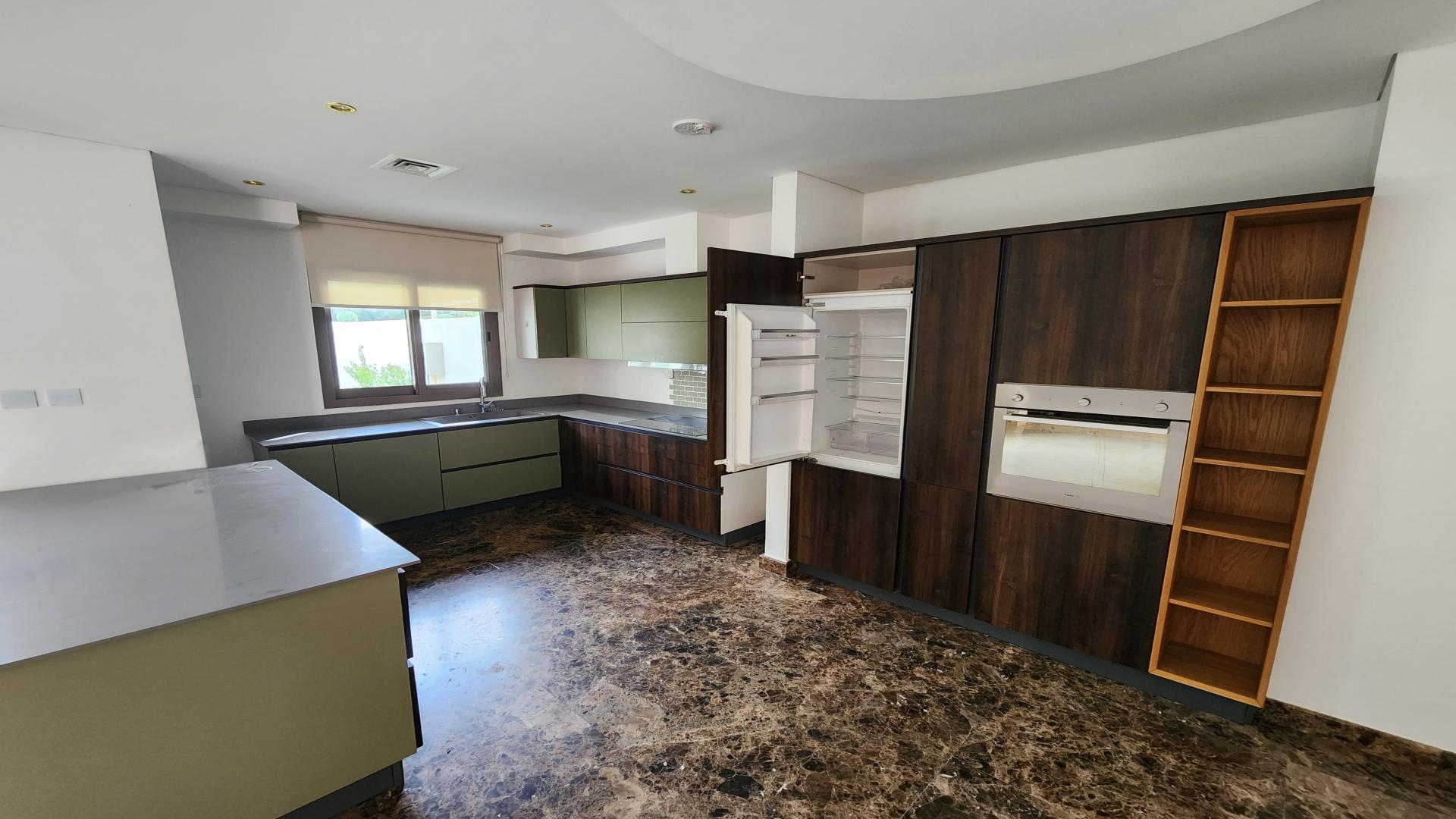 Modern kitchen in 3-bedroom townhouse, Zahra Town Square Dubai, with sleek cabinets and appliances