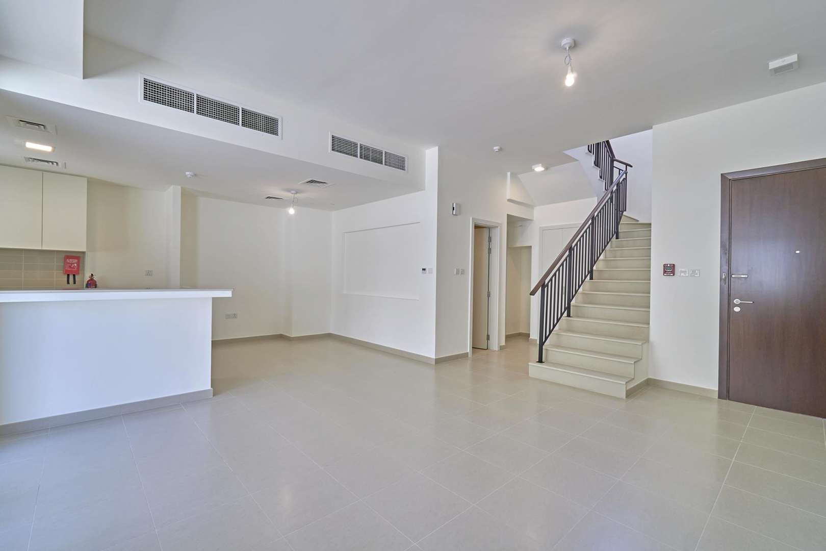 Alt text: "Front view of 3-bedroom townhouse for rent in Naseem, Town Square.",Modern interior of 3-bedroom townhouse for rent in Naseem, Town Square, open-plan design