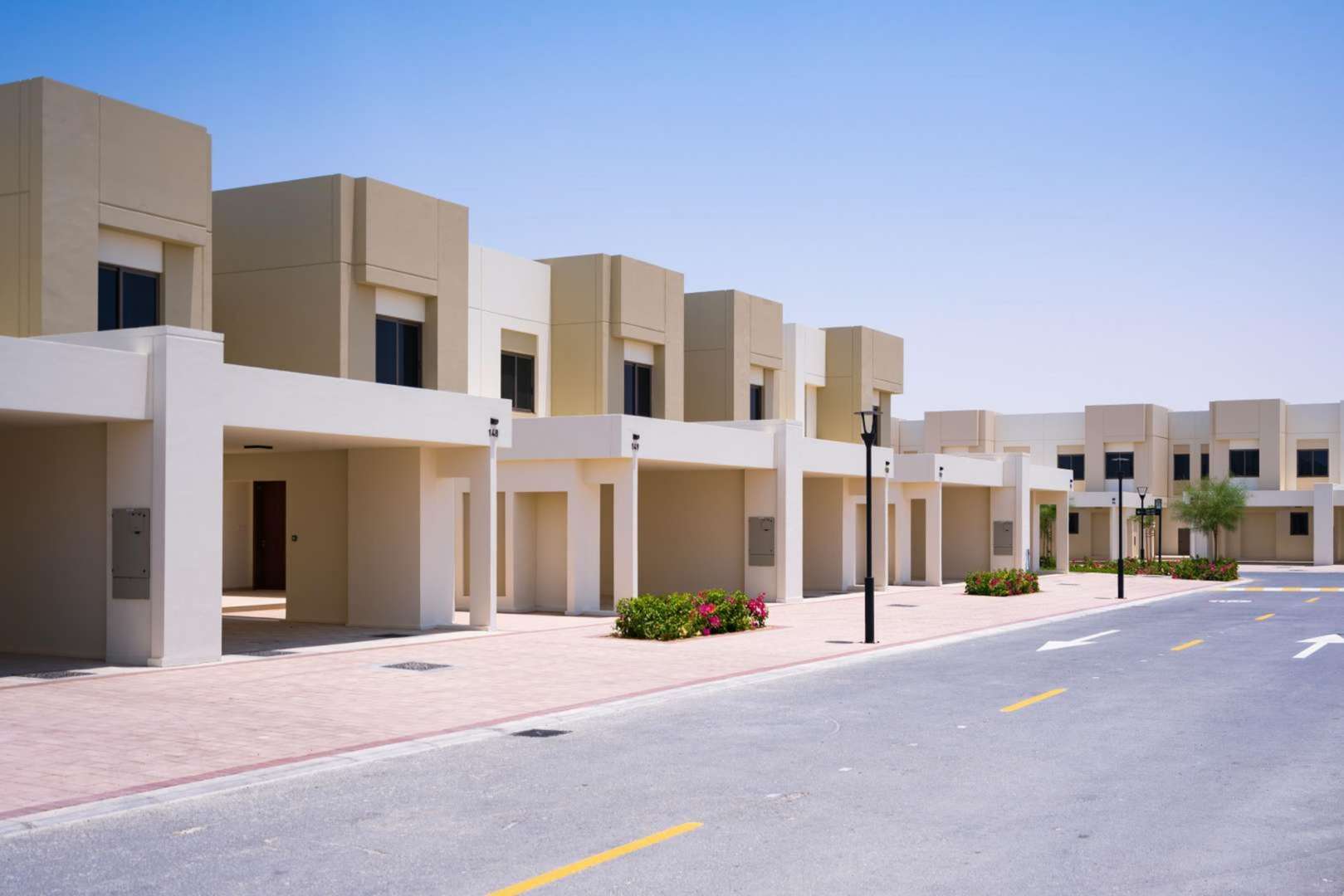 Beautiful landscaped pathway in Naseem Townhouses, Town Square, surrounded by modern residential units