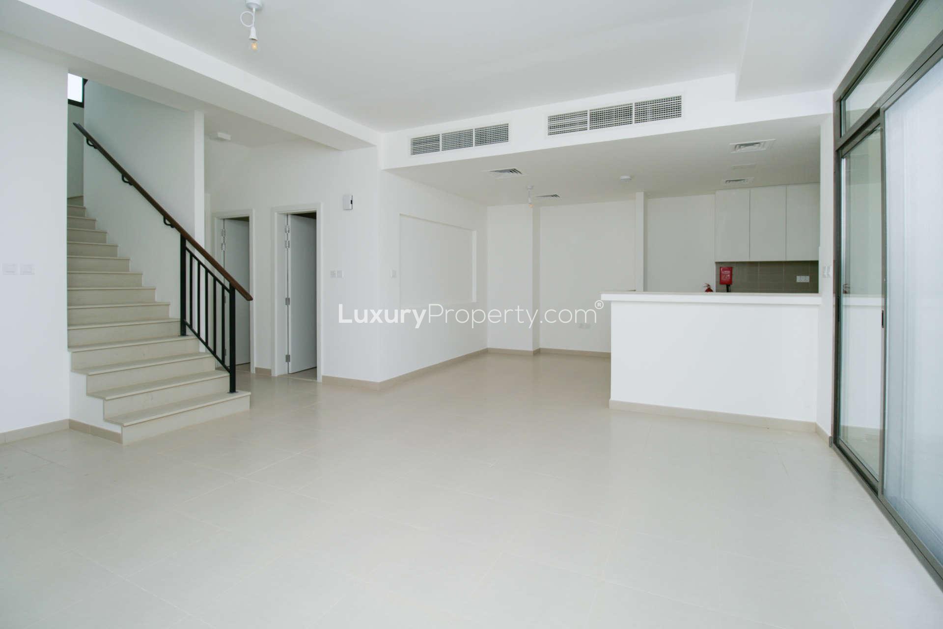 Spacious living area in three-bedroom townhouse, Noor Townhouses, Town Square, for rent