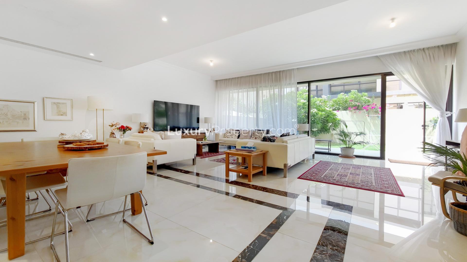 Spacious corner townhouse exterior with carport in Queens Meadow, Damac Hills for rent