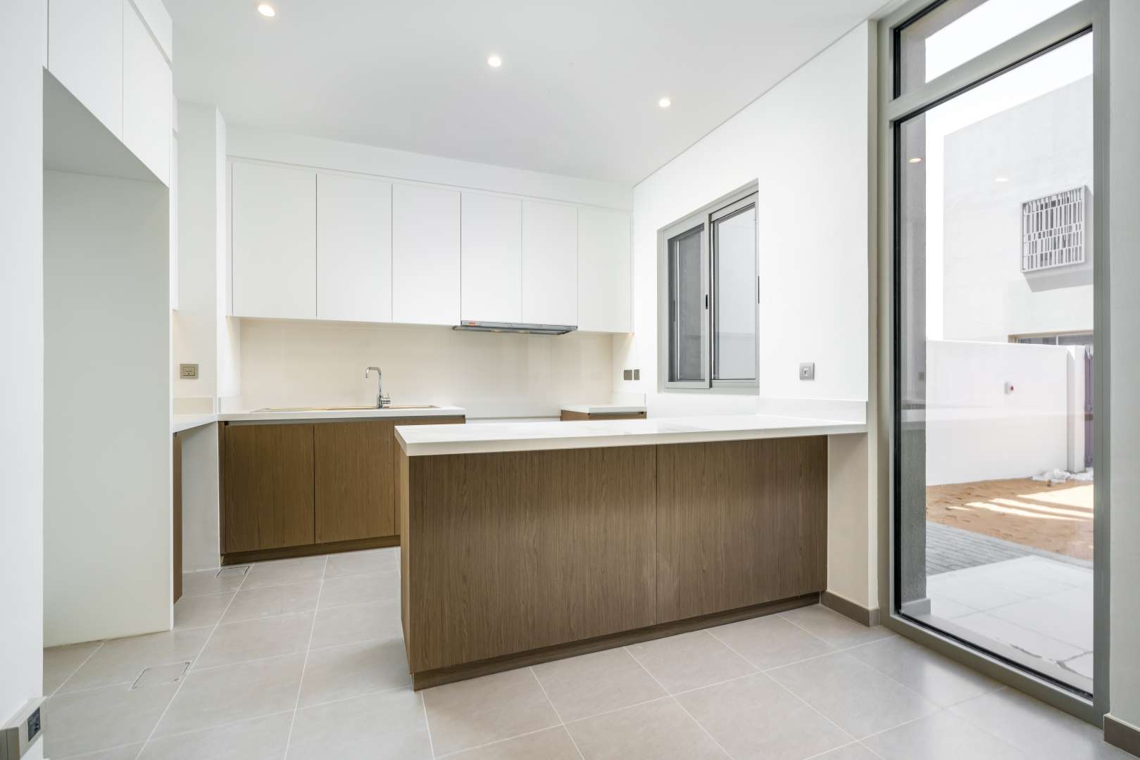 Modern open-plan kitchen and living area in Reem townhouse, Arabian Ranches 2