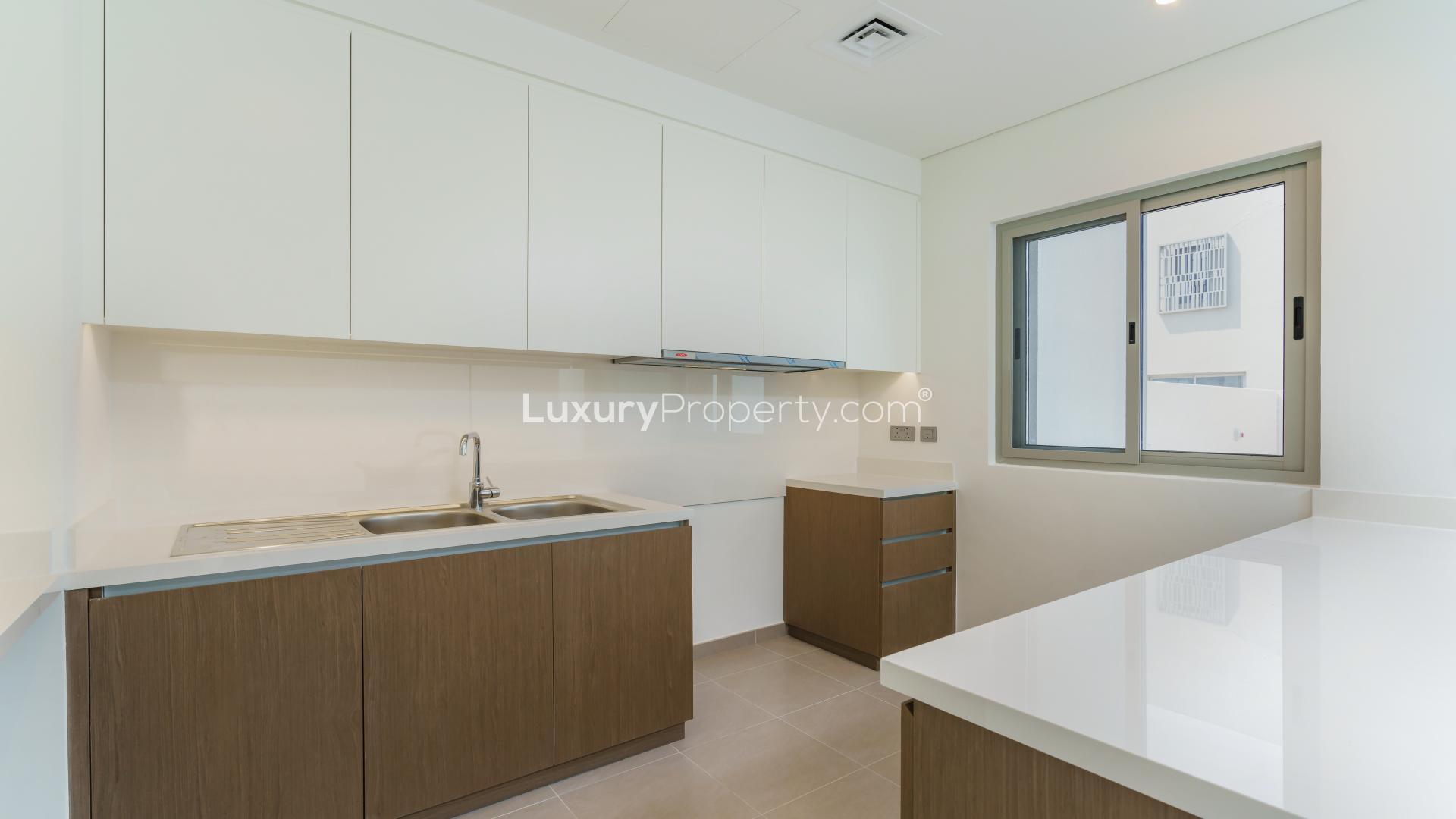 Exterior view of three-bed townhouse with patio in Reem Community, Arabian Ranches 2