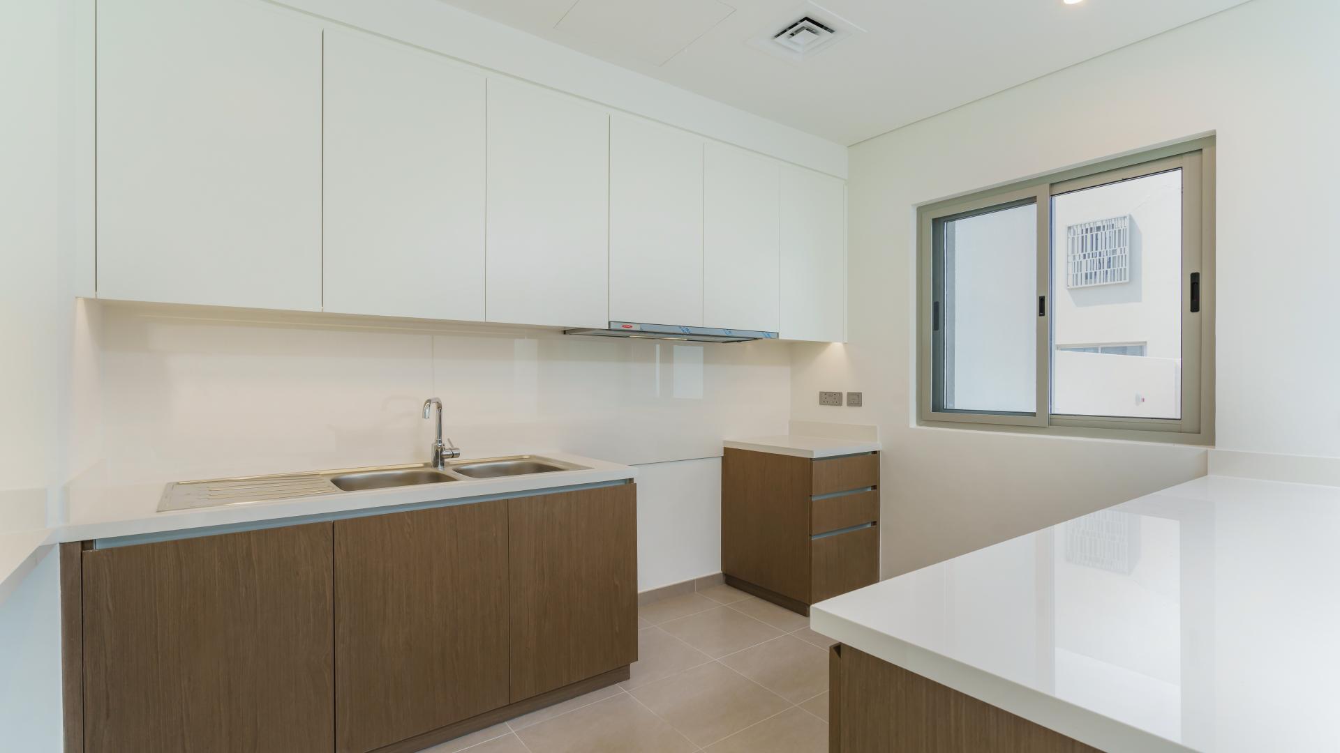 Exterior view of three-bed townhouse with patio in Reem Community, Arabian Ranches 2