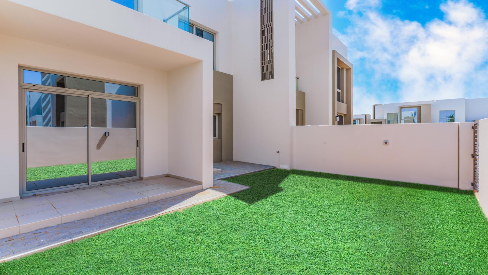 Modern 3-bedroom townhouse exterior in Reem Community, Arabian Ranches 2, for rent