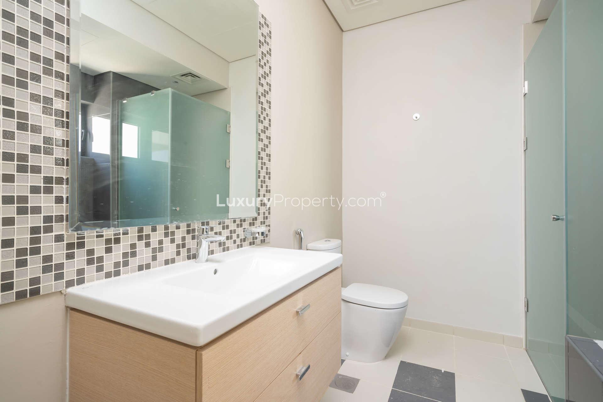 Townhouse exterior with large windows in Richmond, Damac Hills golf community, for rent