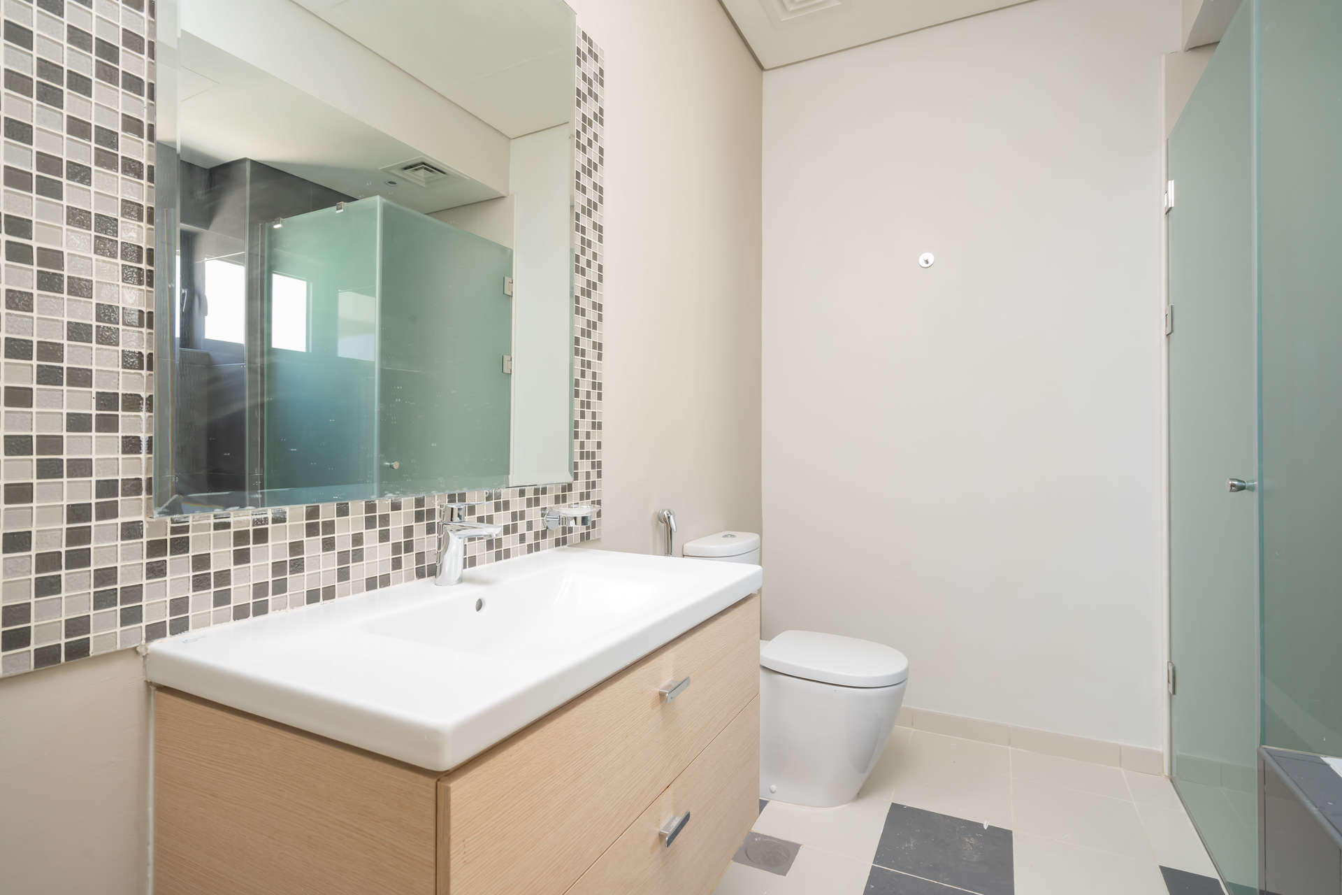 Townhouse exterior with large windows in Richmond, Damac Hills golf community, for rent