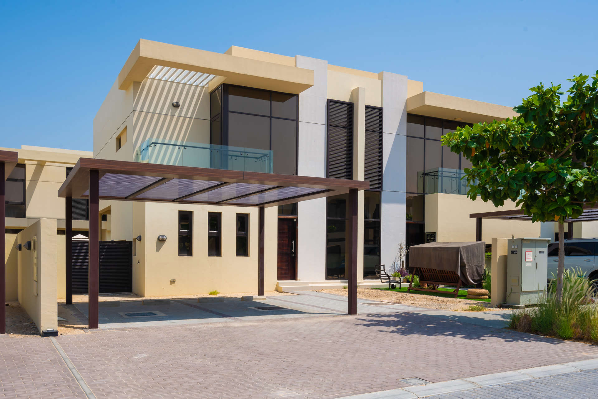 Modern townhouse exterior in Damac Hills' Richmond community, featuring sleek design and spacious driveway