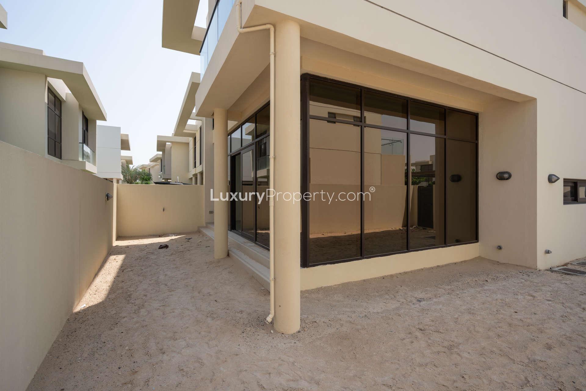 Bright living area with large windows in Richmond, Damac Hills townhouse for rent
