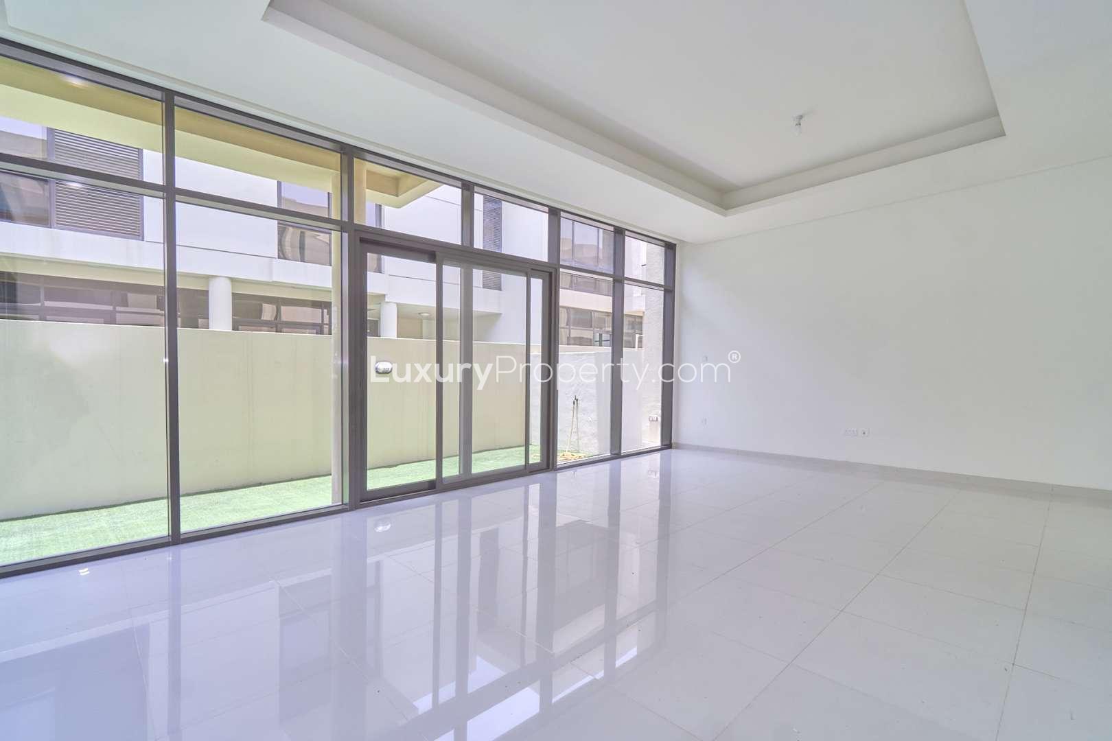 Spacious living area with large windows in Damac Hills Richmond townhouse for rent